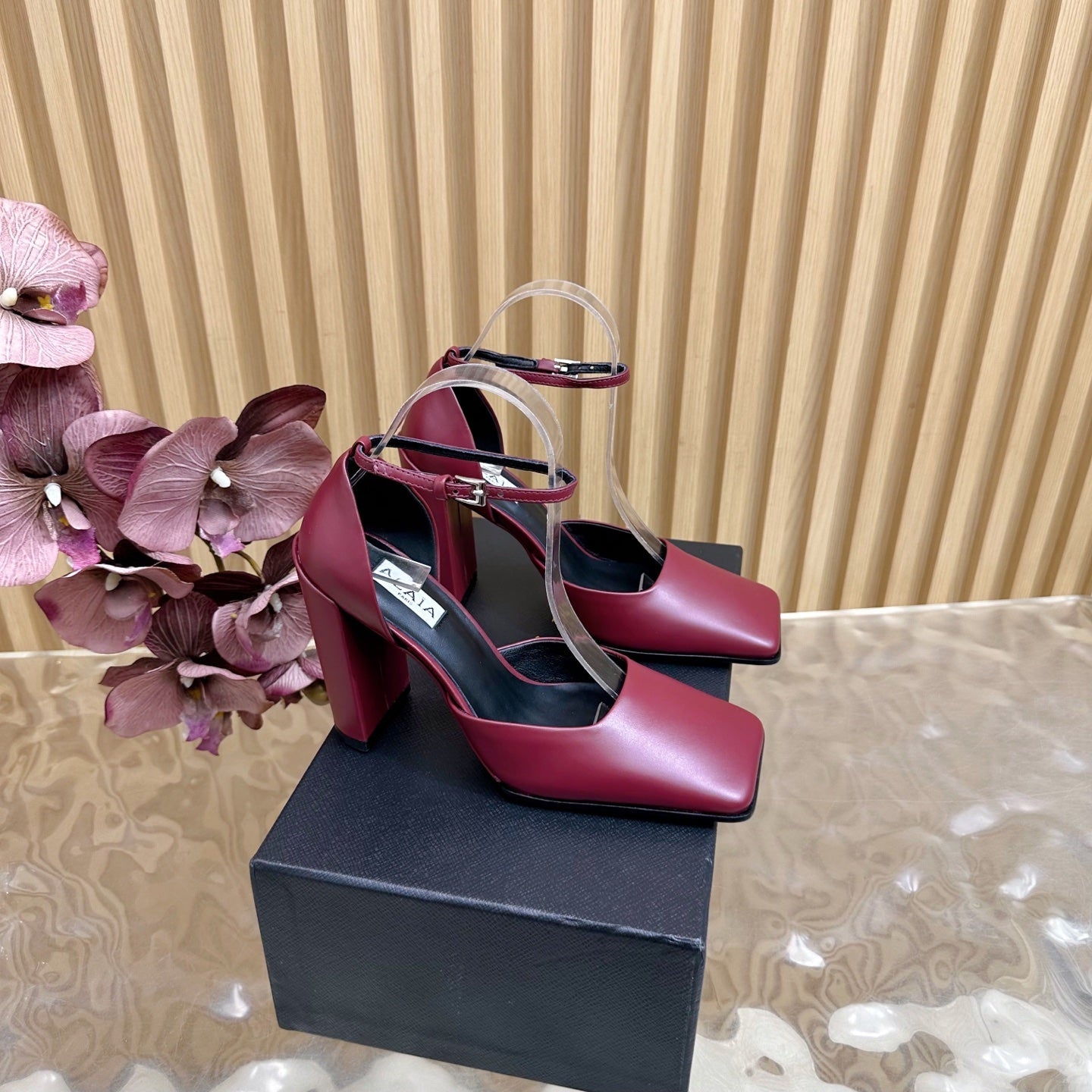 ALAÏA Minimalist Leather Ankle-Strap Block-Heel Pumps