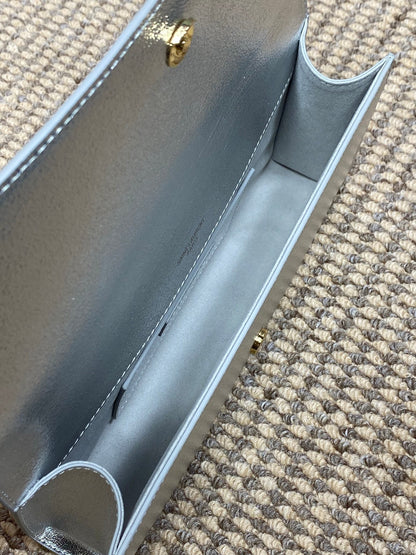 SAINT LAURENT Cassandre Metallic Logo Clutch Bag